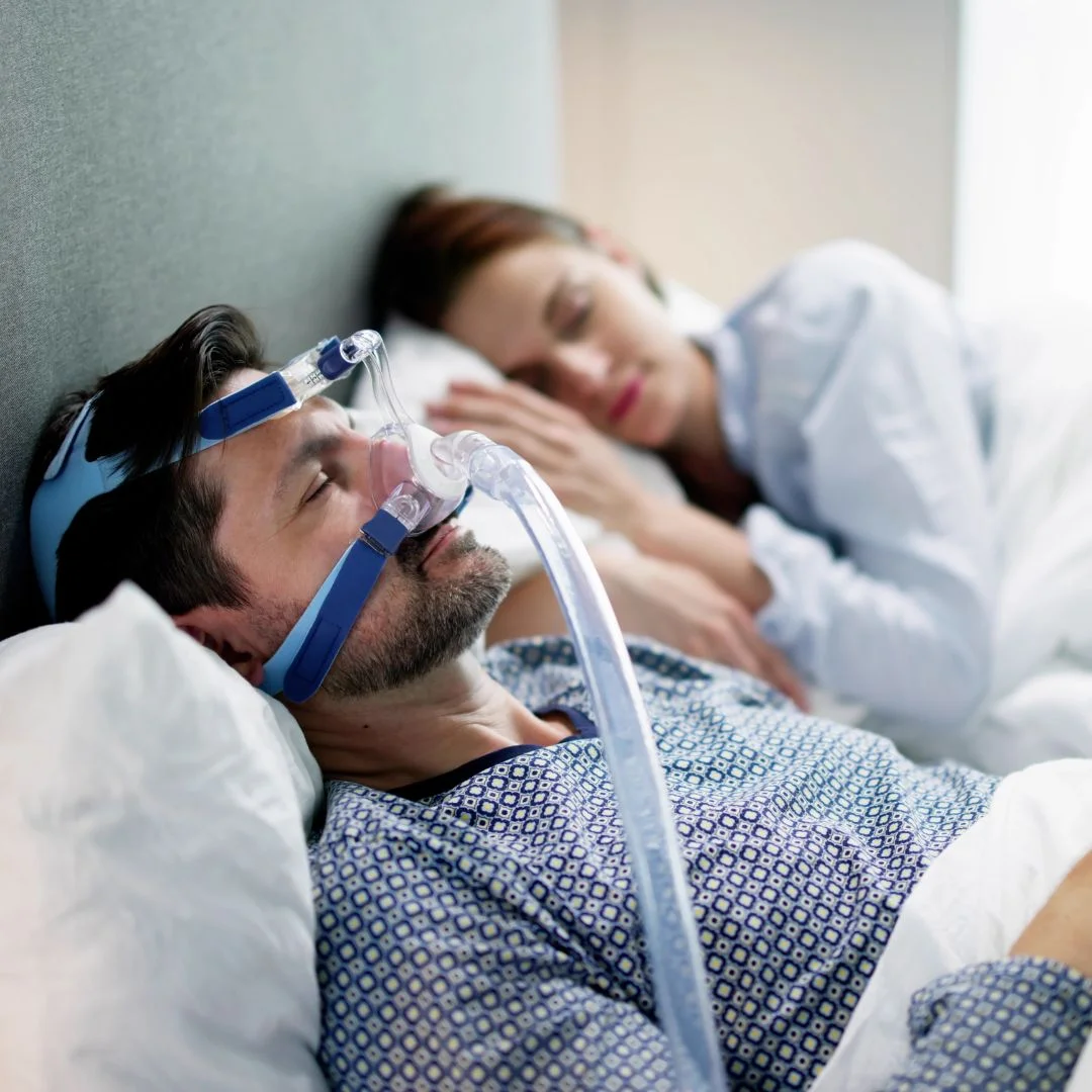 a man sleeping with a CPAP machine