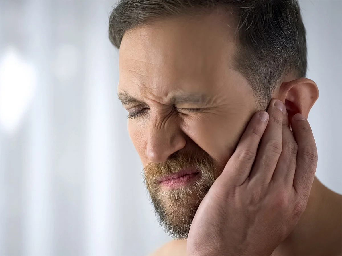 man with ear discomfort