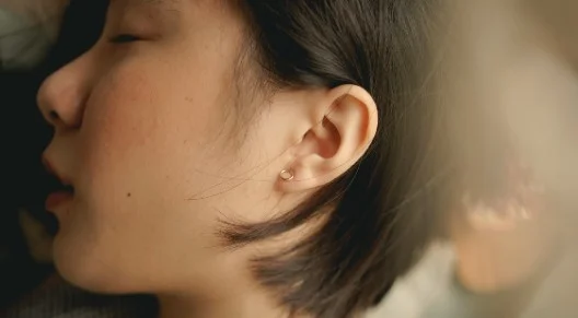 girl sleeping on her side, closeup of ear