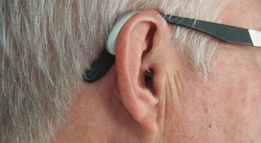 closeup of man's ear with hearing aid