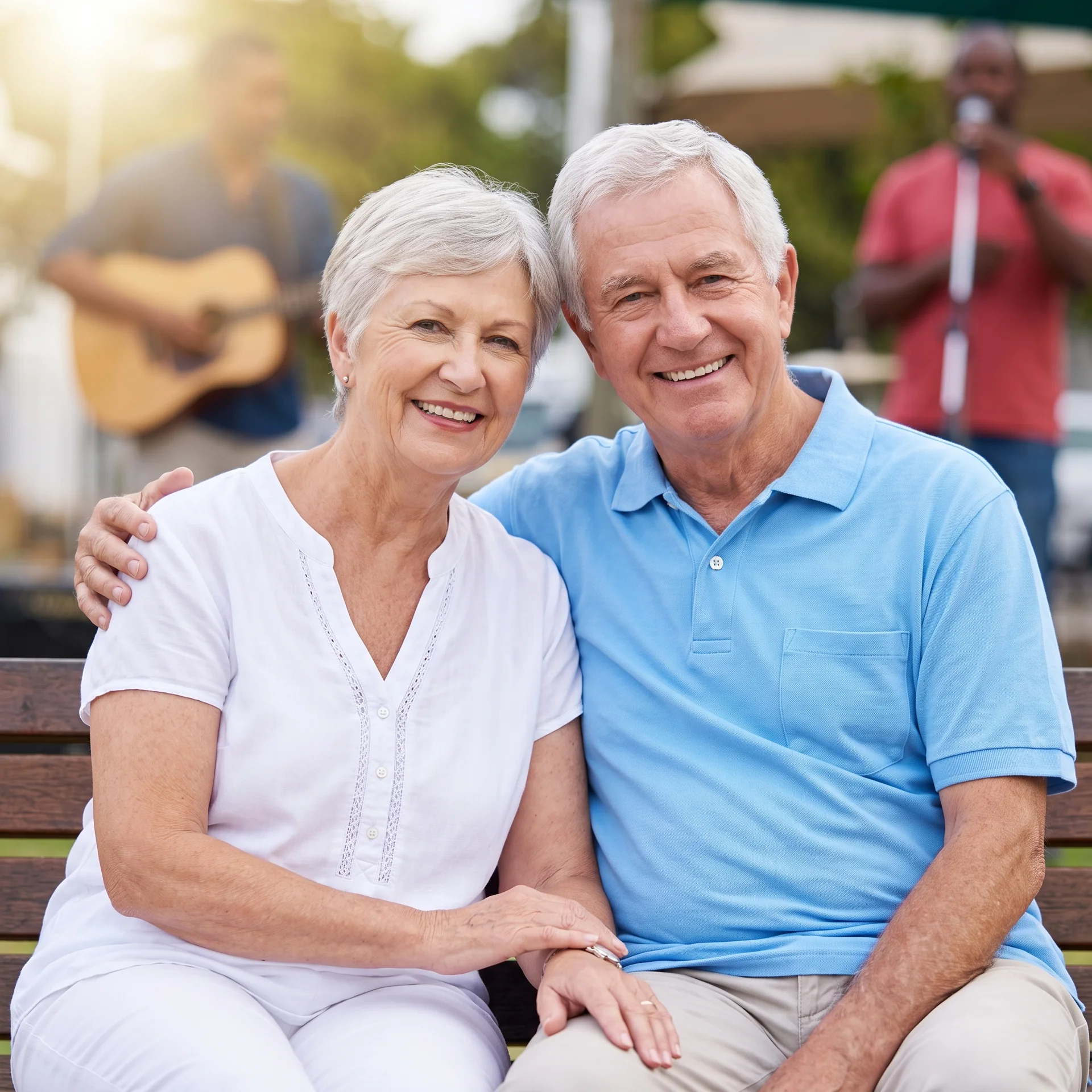 A smiling senior couple enjoys a outdoor music performance.
