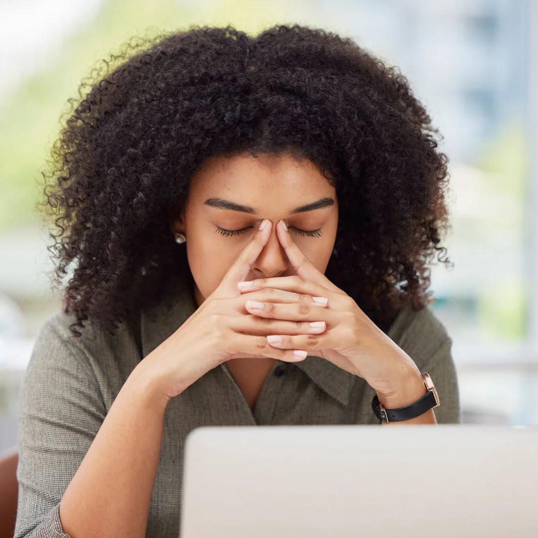 a woman holding her sinuses