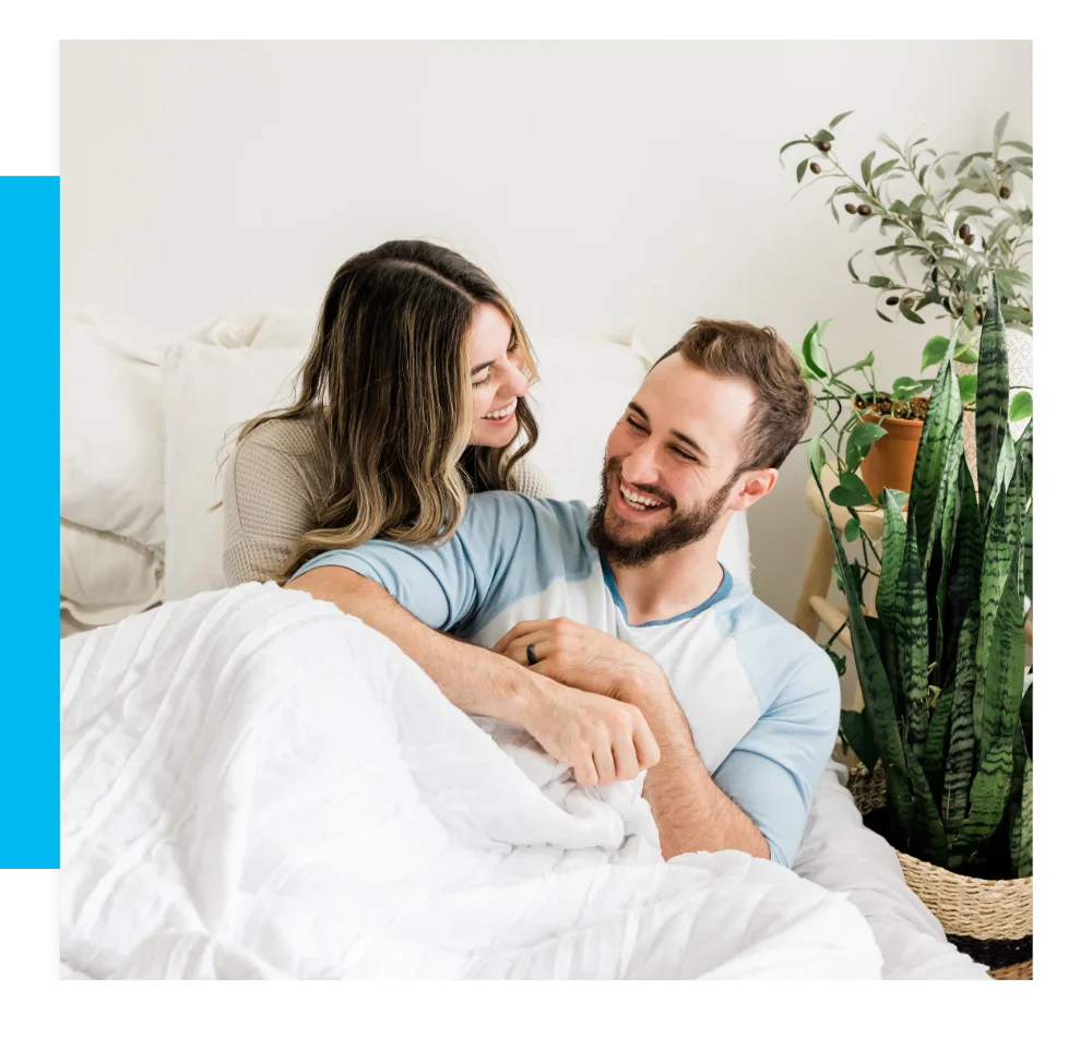 A happy couple in bed.