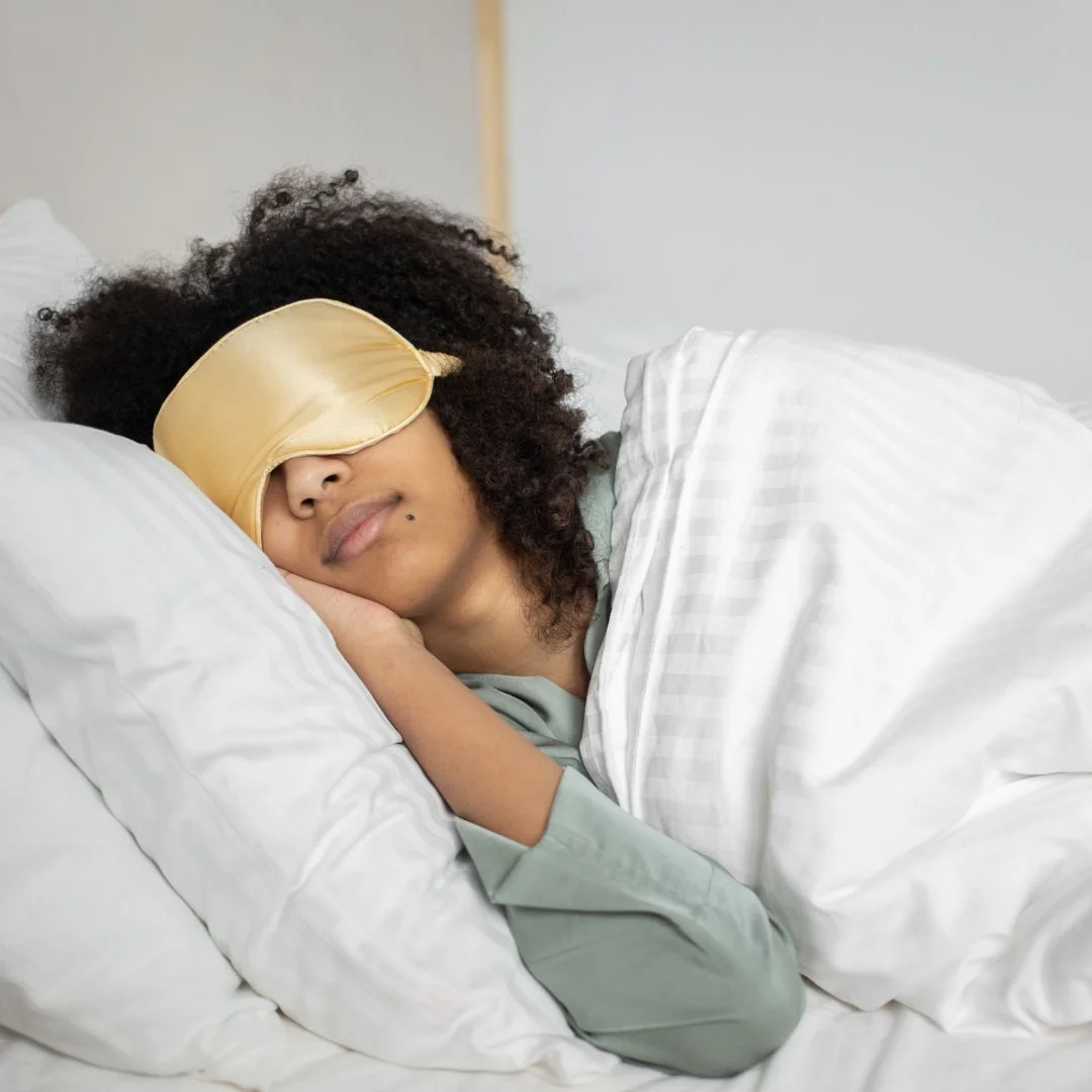 a woman sleeping with a sleep mask
