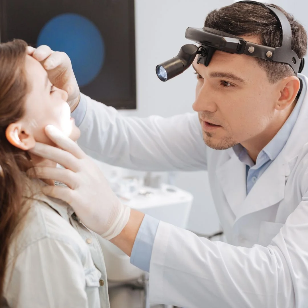 ENT doctor looking in child's mouth