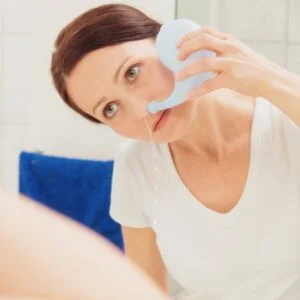 woman using neti pot for sinus pressure relief